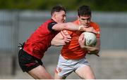 27 April 2024; Jarlath Óg Burns of Armagh is tackled by Ryan McEvoy of Down during the Ulster GAA Football Senior Championship semi-final match between Down and Armagh at St Tiernach's Park in Clones, Monaghan. Photo by Stephen McCarthy/Sportsfile