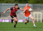 27 April 2024; Oisin Conaty of Armagh is tackled by Finn McElroy of Down during the Ulster GAA Football Senior Championship semi-final match between Down and Armagh at St Tiernach's Park in Clones, Monaghan. Photo by Stephen McCarthy/Sportsfile