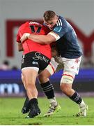 27 April 2024; Gavin Coombes of Munster tackles JP Smith of Emirates Lions during the United Rugby Championship match between Emirates Lions and Munster at Emirates Airline Park in Johannesburg, South Africa. Photo by Shaun Roy/Sportsfile