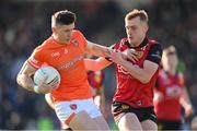 27 April 2024; Joe McElroy of Armagh in action against Liam Kerr of Down during the Ulster GAA Football Senior Championship semi-final match between Down and Armagh at St Tiernach's Park in Clones, Monaghan. Photo by Stephen McCarthy/Sportsfile