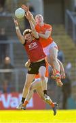 27 April 2024; Miceal Rooney of Down in action against Ciaran Mackin of Armagh during the Ulster GAA Football Senior Championship semi-final match between Down and Armagh at St Tiernach's Park in Clones, Monaghan. Photo by Stephen McCarthy/Sportsfile