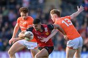 27 April 2024; Finn McElroy of Down is tackled by Conor Turbitt and Jason Duffy, left, of Armagh during the Ulster GAA Football Senior Championship semi-final match between Down and Armagh at St Tiernach's Park in Clones, Monaghan. Photo by Stephen McCarthy/Sportsfile