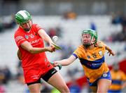 28 April 2024; Hannah Looney of Cork is tackled by Labhaoise O’Donnell of Clare during the Munster Senior Camogie Championship semi-final match between Cork and Clare at SuperValu Páirc Ui Chaoimh in Cork. Photo by Ray McManus/Sportsfile