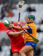 28 April 2024; Hannah Looney of Cork is tackled by Niamh Mulqueen of Clare during the Munster Senior Camogie Championship semi-final match between Cork and Clare at SuperValu Páirc Ui Chaoimh in Cork. Photo by Ray McManus/Sportsfile