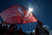 28 April 2024; A Tyrone supporters flies a flag on the terrace before the Ulster GAA Football Senior Championship semi-final match between Donegal and Tyrone at Celtic Park in Derry. Photo by Stephen McCarthy/Sportsfile