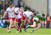 28 April 2024; Ciaran Moore of Donegal in action against Tyrone players, from left, Conn Kilpatrick, Cathal McShane and Brian Kennedy during the Ulster GAA Football Senior Championship semi-final match between Donegal and Tyrone at Celtic Park in Derry. Photo by Stephen McCarthy/Sportsfile