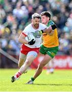 28 April 2024; Matthew Donnelly of Tyrone is tackled by Daire Ó Baoill of Donegal during the Ulster GAA Football Senior Championship semi-final match between Donegal and Tyrone at Celtic Park in Derry. Photo by Stephen McCarthy/Sportsfile
