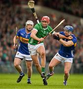 28 April 2024; Barry Nash of Limerick is tackled by Willie Connors and Johnny Ryan of Tipperary during the Munster GAA Hurling Senior Championship Round 2 match between Limerick and Tipperary at TUS Gaelic Grounds in Limerick. Photo by Brendan Moran/Sportsfile