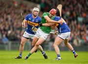 28 April 2024; Barry Nash of Limerick is tackled by Willie Connors and Johnny Ryan of Tipperary during the Munster GAA Hurling Senior Championship Round 2 match between Limerick and Tipperary at TUS Gaelic Grounds in Limerick. Photo by Brendan Moran/Sportsfile