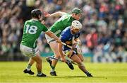 28 April 2024; Johnny Ryan of Tipperary is tackled by Peter Casey and Cathal O'Neill of Limerick during the Munster GAA Hurling Senior Championship Round 2 match between Limerick and Tipperary at TUS Gaelic Grounds in Limerick. Photo by Brendan Moran/Sportsfile