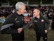 28 April 2024; Donegal manager Jim McGuinness and Tyrone joint-manager Brian Dooher shake hands after the Ulster GAA Football Senior Championship semi-final match between Donegal and Tyrone at Celtic Park in Derry. Photo by Stephen McCarthy/Sportsfile