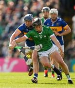 28 April 2024; Peter Casey of Limerick is tackled by Alan Tynan of Tipperary during the Munster GAA Hurling Senior Championship Round 2 match between Limerick and Tipperary at TUS Gaelic Grounds in Limerick. Photo by Brendan Moran/Sportsfile