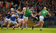 28 April 2024; Gearóid Hegarty of Limerick is tackled by Willie Connors and Mikey Breen of Tipperary during the Munster GAA Hurling Senior Championship Round 2 match between Limerick and Tipperary at TUS Gaelic Grounds in Limerick. Photo by Brendan Moran/Sportsfile