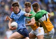 28 April 2024; Tom Lahiff of Dublin is tackled by Rory Egan, behind, and Peter Cunningham of Offaly during the Leinster GAA Football Senior Championship semi-final match between Dublin and Offaly at Croke Park in Dublin. Photo by Shauna Clinton/Sportsfile
