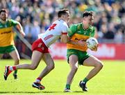 28 April 2024; Michael Langan of Donegal is tackled by Darragh Canavan of Tyrone during the Ulster GAA Football Senior Championship semi-final match between Donegal and Tyrone at Celtic Park in Derry. Photo by Stephen McCarthy/Sportsfile
