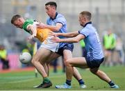 28 April 2024; Peter Cunningham of Offaly is tackled by Cormac Costello, behind, and Paul Mannion of Dublin during the Leinster GAA Football Senior Championship semi-final match between Dublin and Offaly at Croke Park in Dublin. Photo by Shauna Clinton/Sportsfile