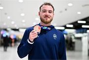 28 April 2024; Barry McClements poses with his bronze medal from the Men's 100m Butterfly S9 at Dublin Airport as the Irish Para Swimming Team return home from the Para Swimming European Championships in Portugal. Photo by Ben McShane/Sportsfile