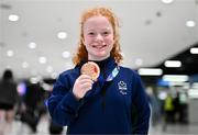 28 April 2024; Dearbhaile Brady poses with her bronze medal from the Women's 50m Freestyle S6 at Dublin Airport as the Irish Para Swimming Team return home from the Para Swimming European Championships in Portugal. Photo by Ben McShane/Sportsfile