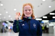 28 April 2024; Dearbhaile Brady poses with her bronze medal from the Women's 50m Freestyle S6 at Dublin Airport as the Irish Para Swimming Team return home from the Para Swimming European Championships in Portugal. Photo by Ben McShane/Sportsfile