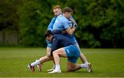 29 April 2024; Garry Ringrose is tackled by Ciarán Frawley, left, and James Lowe during Leinster rugby squad training at UCD in Dublin. Photo by Brendan Moran/Sportsfile