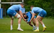 29 April 2024; Jamison Gibson-Park is tackled by Ross Molony, left, and Jordan Larmour during Leinster rugby squad training at UCD in Dublin. Photo by Brendan Moran/Sportsfile