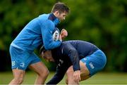 29 April 2024; Ross Byrne is tackled by James Lowe during Leinster rugby squad training at UCD in Dublin. Photo by Brendan Moran/Sportsfile