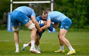 29 April 2024; Jamison Gibson-Park is tackled by Ross Molony and Jordan Larmour during Leinster rugby squad training at UCD in Dublin. Photo by Brendan Moran/Sportsfile