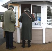 30 April 2024; Racegoers buy racecards during day one of the Punchestown Festival at Punchestown Racecourse in Kildare. Photo by David Fitzgerald/Sportsfile