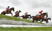 30 April 2024; Knockiel Synge, with Georgie Benson up, right, jump Ruby's Double on their way to winning the Kildare Hunt Club Cross Country Steeplechase for the Ladies Perpetual Cup during day one of the Punchestown Festival at Punchestown Racecourse in Kildare. Photo by David Fitzgerald/Sportsfile