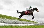 30 April 2024; Three By Two, with Jack Hendrick up, jump Ruby's Double in the Kildare Hunt Club Cross Country Steeplechase for the Ladies Perpetual Cup during day one of the Punchestown Festival at Punchestown Racecourse in Kildare. Photo by David Fitzgerald/Sportsfile