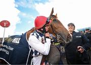 30 April 2024; JJ Slevin, left, kisses Banbridge after winning the William Hill Champion Steeplechase during day one of the Punchestown Festival at Punchestown Racecourse in Kildare.