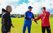 1 May 2024; Leinster Lightning captain George Dockrell, centre, performs the coin toss alongside Munster Reds captain PJ Moor, right, and match official Graham McRea before the Cricket Ireland Inter-Provincial Trophy match between Leinster Lightning and Munster Reds at Pembroke Cricket Club in Dublin. Photo by Tyler Miller/Sportsfile