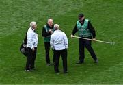 28 April 2024; Umpires Greg McGrath, left, and Aiden Woods in conversation with groundsmen Sam Kingston and Aidan Ryan, right, at half-time during the Leinster GAA Football Senior Championship semi-final match between Dublin and Offaly at Croke Park in Dublin. Photo by Piaras Ó Mídheach/Sportsfile