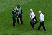 28 April 2024; Umpires Greg McGrath and Aiden Woods, right, make their way to their positions for the second half, as groundsmen Sam Kingston, left, and Aidan Ryan tend to the pitch at half-time during the Leinster GAA Football Senior Championship semi-final match between Dublin and Offaly at Croke Park in Dublin. Photo by Piaras Ó Mídheach/Sportsfile