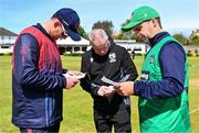 1 May 2024; Northern Knights captain Mark Adair, left, and North West Warriors captain Andy McBrine inpsect the team sheets before the Cricket Ireland Inter-Provincial Trophy match between Northern Knights and North West Warriors at Pembroke Cricket Club in Dublin. Photo by Tyler Miller/Sportsfile