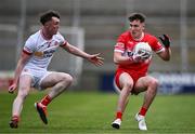 1 May 2024; Conall Heron of Derry in action against Ronan Fox of Tyrone during the EirGrid Ulster GAA U20 Football Championship Final match between Derry and Tyrone at the Box-It Athletic Grounds in Armagh. Photo by Ben McShane/Sportsfile