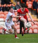 1 May 2024; Shea McCann of Derry is tackled by Conor Devlin of Tyrone during the EirGrid Ulster GAA U20 Football Championship Final match between Derry and Tyrone at the Box-It Athletic Grounds in Armagh. Photo by Ben McShane/Sportsfile