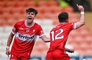1 May 2024; Johnny McGuckian of Derry, right, celebrates with teammate Oisin Doherty after scoring their side's first goal during the EirGrid Ulster GAA U20 Football Championship Final match between Derry and Tyrone at the Box-It Athletic Grounds in Armagh. Photo by Ben McShane/Sportsfile