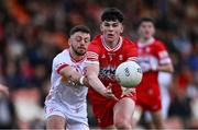1 May 2024; Conleth McGrogan of Derry is tackled by Michael Rafferty of Tyrone during the EirGrid Ulster GAA U20 Football Championship Final match between Derry and Tyrone at the Box-It Athletic Grounds in Armagh. Photo by Ben McShane/Sportsfile