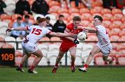 1 May 2024; Niall O'Donnell of Derry is tackled by Ronan Cassidy, left, and Conor Devlin of Tyrone during the EirGrid Ulster GAA U20 Football Championship Final match between Derry and Tyrone at the Box-It Athletic Grounds in Armagh. Photo by Ben McShane/Sportsfile