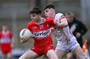 1 May 2024; Shea McCann of Derry is tackled by Eoin McElholm of Tyrone during the EirGrid Ulster GAA U20 Football Championship Final match between Derry and Tyrone at the Box-It Athletic Grounds in Armagh. Photo by Ben McShane/Sportsfile