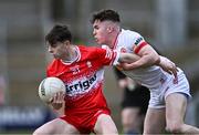 1 May 2024; Shea McCann of Derry is tackled by Eoin McElholm of Tyrone during the EirGrid Ulster GAA U20 Football Championship Final match between Derry and Tyrone at the Box-It Athletic Grounds in Armagh. Photo by Ben McShane/Sportsfile