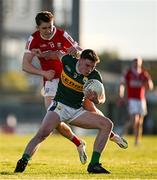 1 May 2024; Eddie Healy of Kerry is tackled by Olan Corcoran of Cork during the EirGrid Munster GAA U20 Football Championship Final match between Kerry and Cork at Austin Stack Park in Tralee, Kerry. Photo by Brendan Moran/Sportsfile