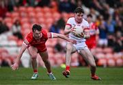 1 May 2024; Ronan Cassidy of Tyrone is tackled by Ronan Walls of Derry during the EirGrid Ulster GAA U20 Football Championship Final match between Derry and Tyrone at the Box-It Athletic Grounds in Armagh. Photo by Ben McShane/Sportsfile