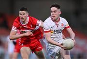 1 May 2024; Eoin McElholm of Tyrone in action against Rory McGill of Derry during the EirGrid Ulster GAA U20 Football Championship Final match between Derry and Tyrone at the Box-It Athletic Grounds in Armagh. Photo by Ben McShane/Sportsfile