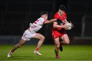1 May 2024; Conleth McGrogan of Derry is tackled by Gavin Potter of Tyrone during the EirGrid Ulster GAA U20 Football Championship Final match between Derry and Tyrone at the Box-It Athletic Grounds in Armagh. Photo by Ben McShane/Sportsfile