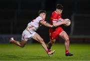 1 May 2024; Conleth McGrogan of Derry is tackled by Gavin Potter of Tyrone during the EirGrid Ulster GAA U20 Football Championship Final match between Derry and Tyrone at the Box-It Athletic Grounds in Armagh. Photo by Ben McShane/Sportsfile