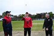 2 May 2024; PJ Moor of Munster Reds tosses the coin watched by Mark Adair of Northern Knights and Match referee Graham McCrea before the Cricket Ireland Inter-Provincial Trophy match between Munster Reds and Northern Knights at Pembroke Cricket Club in Dublin. Photo by Harry Murphy/Sportsfile