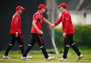 2 May 2024; John McNally of Munster Reds, centre, celebrates with teammate Jordan Neil after catching out James McCollum of Northern Knights during the Cricket Ireland Inter-Provincial Trophy match between Munster Reds and Northern Knights at Pembroke Cricket Club in Dublin. Photo by Harry Murphy/Sportsfile
