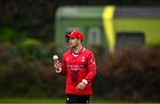 2 May 2024; Curtis Campher of Munster Reds fields as a Dart train passes during the Cricket Ireland Inter-Provincial Trophy match between Munster Reds and Northern Knights at Pembroke Cricket Club in Dublin. Photo by Harry Murphy/Sportsfile